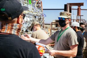 Airmen directing personnel at the liquid rocket CONOPS and novel deployable systems test site.