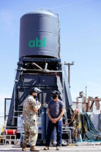 Airmen touring the liquid rocket CONOPS and novel deployable systems site, standing in front of a tower.