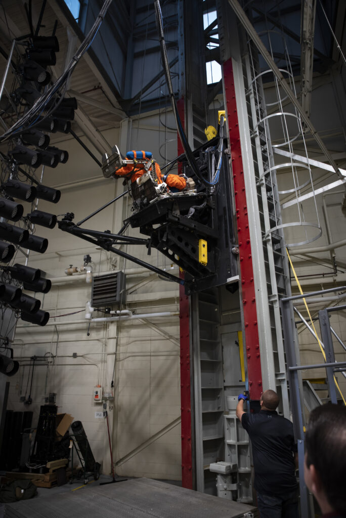 The vertical deceleration tower at Wright-Patterson Air Force Base with a U.S. Air Force volunteer strapped in testing a new space suit and seat combo for upcoming Orion spacecraft missions.
