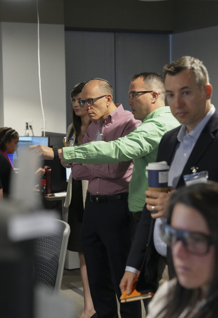 visitors testing software while leaders explain the details of the MASH experiment