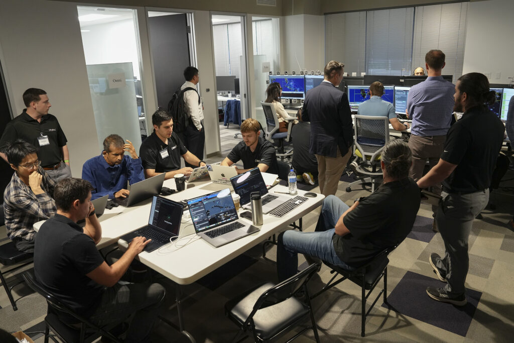 participants gathering around table for testing and demonstrations