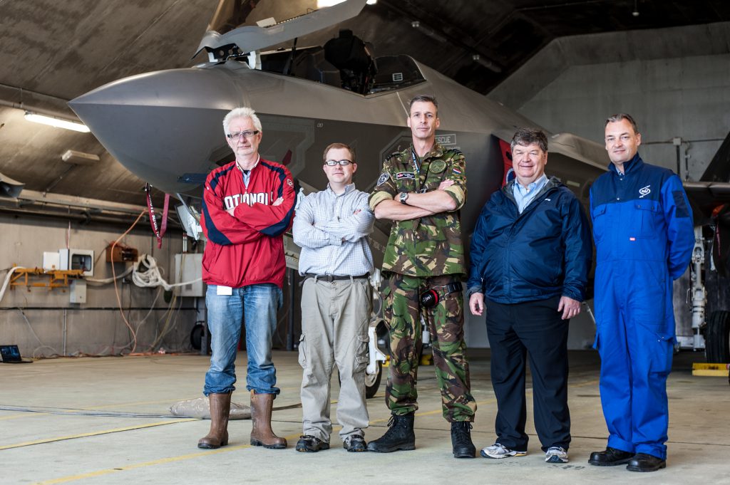 team of scientists in front of F-35