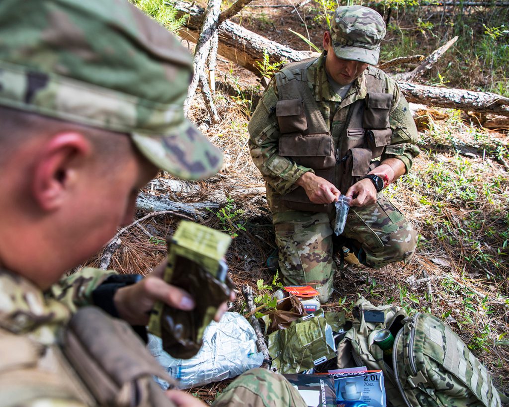 soldiers looking at survival gear