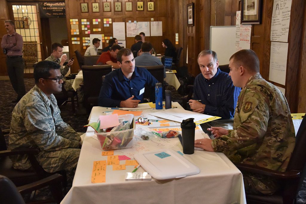 image of various personnel talking at table