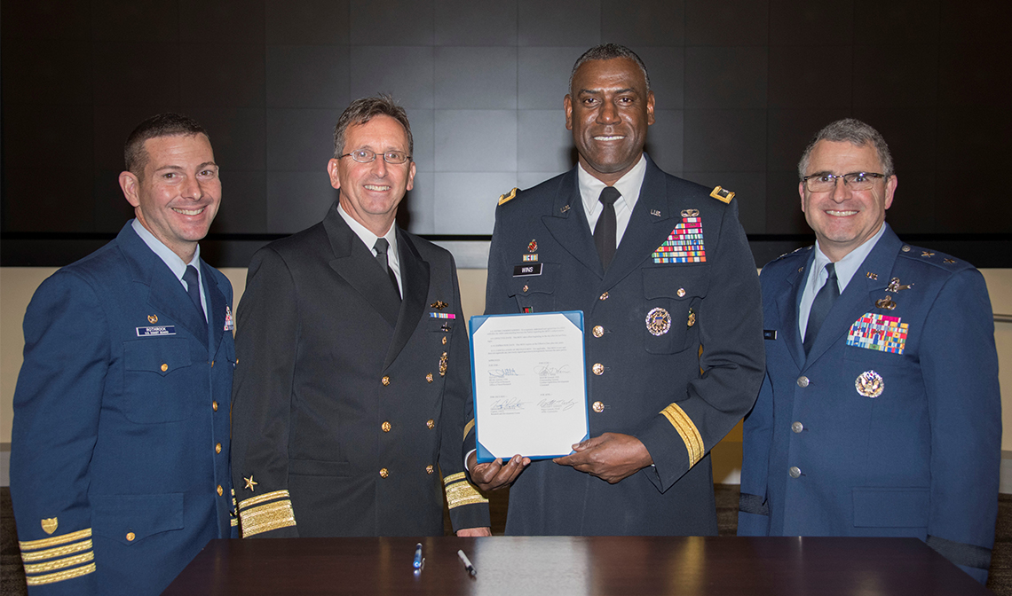 Following a “Laboratory Commanders Sync” meeting Oct. 28, leaders from Department of Defense and Department of Homeland Security service laboratories signed a memorandum of understanding for an expanded working relationship marked by cooperation and collaboration in a broad range of activities, especially in areas of mutual benefit. Left to right: Capt. Gregory Rothrock from the U.S. Coast Guard Research and Development Center; Rear Adm. David Hahn, chief of the Office of Naval Research; Maj. Gen Cedric Wins, commanding general, Army Combat Capabilities Development Command and Maj. Gen. William Cooley, Air Force Research Laboratory commander. (U.S. Air Force photo/Airman 1st Class Spencer Slocum)