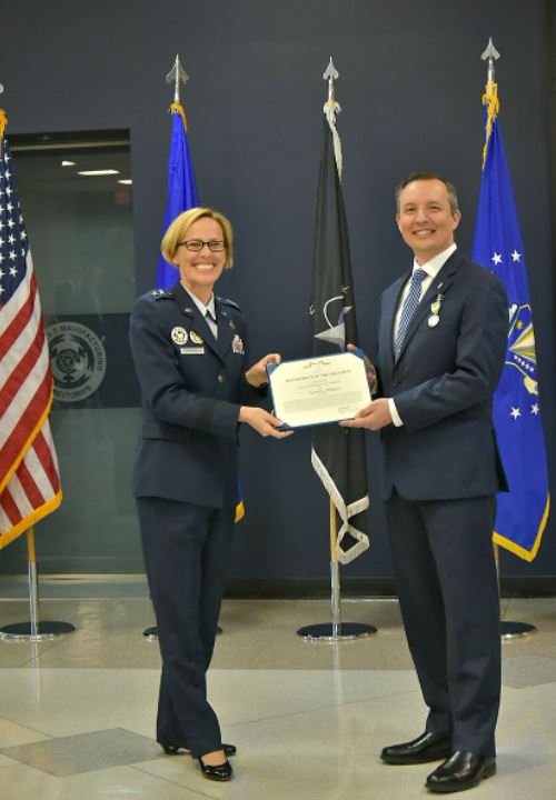 AFRL Commander Gen. Heather Pringle presents Mr. Darrell Phillipson with the Meritorious Civilian Service Award.