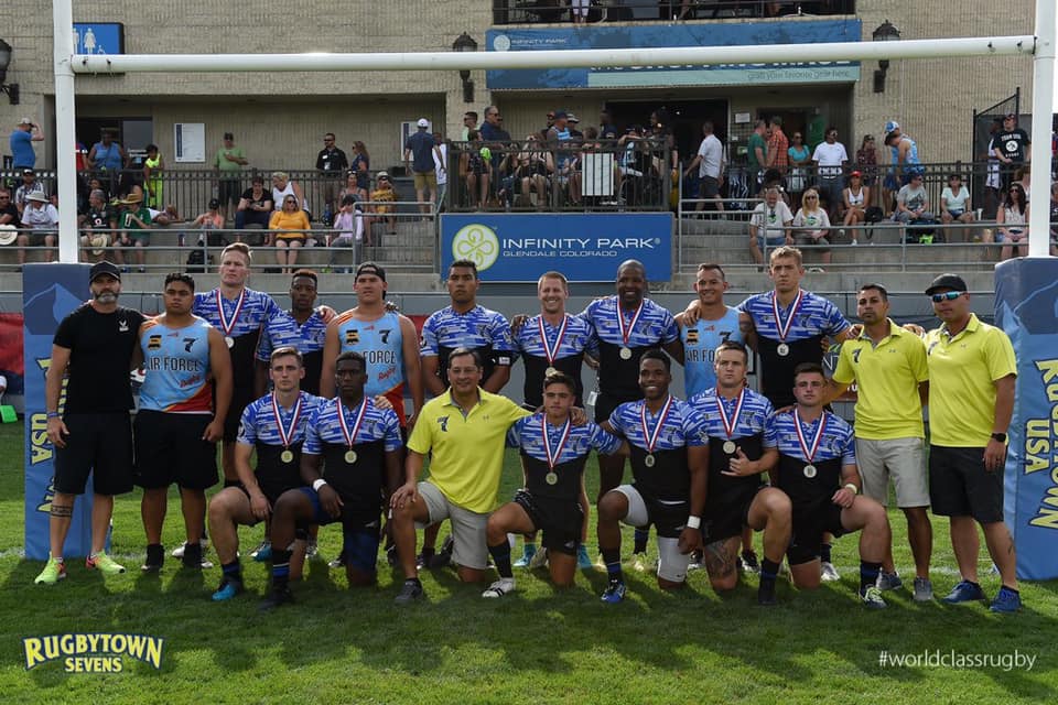 Team of Air Force Rugby players kneeling while facing the camera.