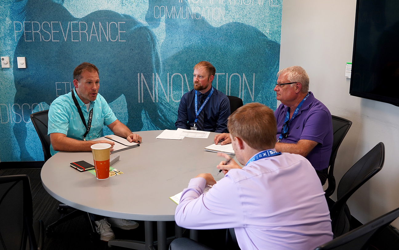 industry leaders around a round table in discussions