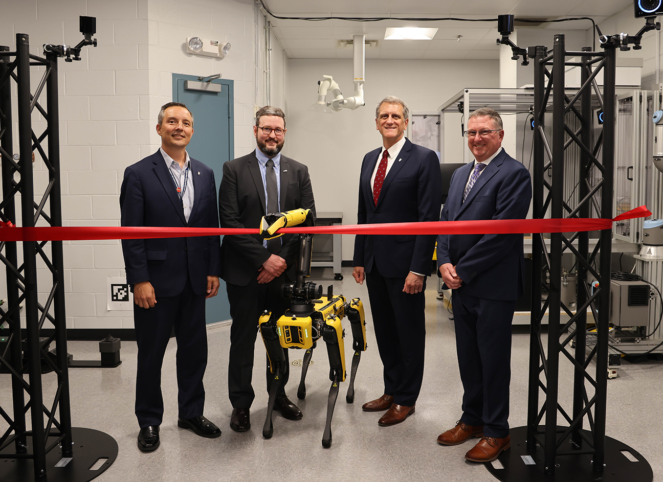 leadership and robot Astro perform ribbon cutting