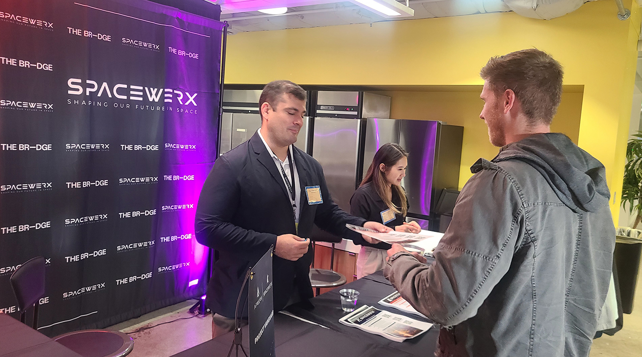 presenters engaging with visitors during event