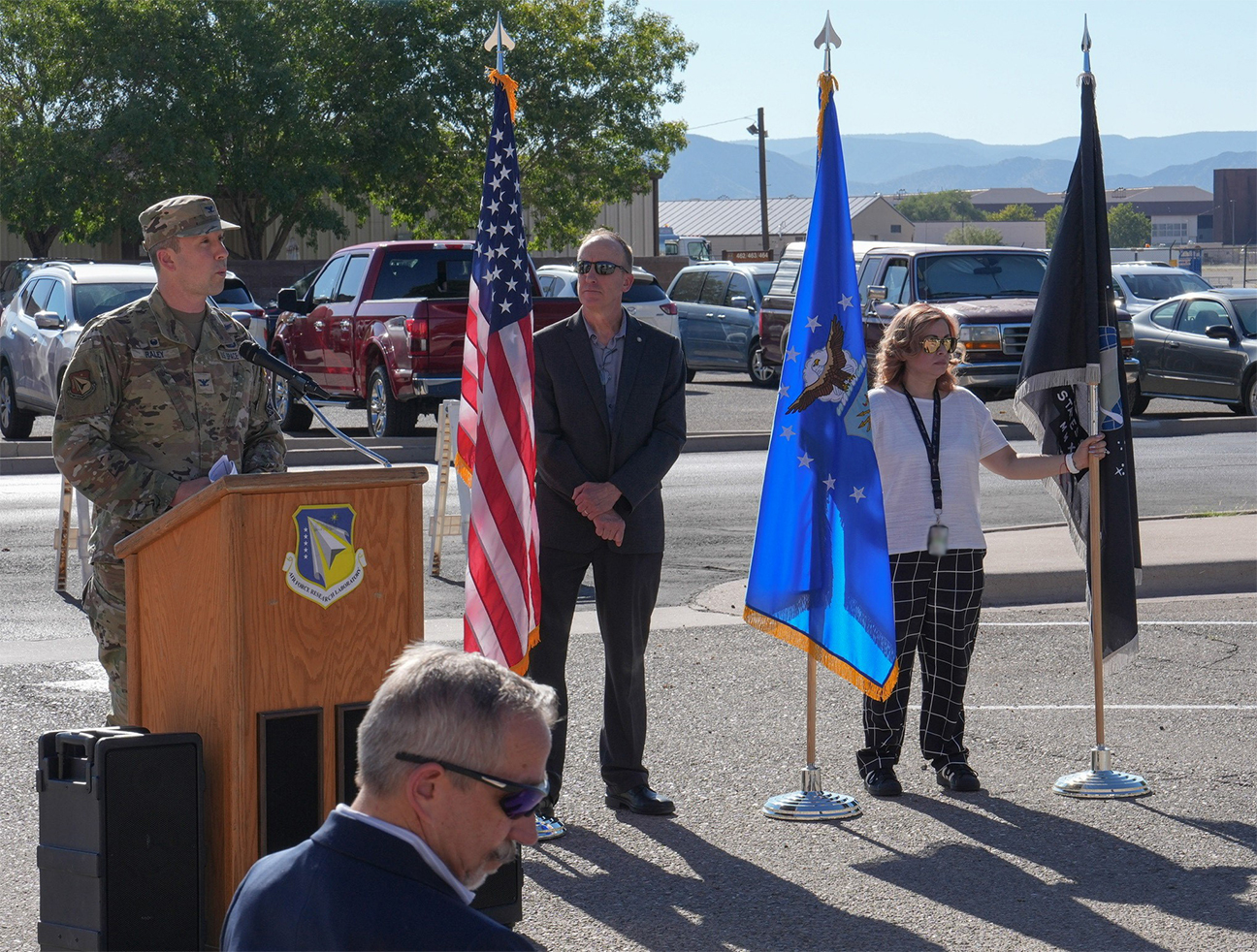 ceremony attendees standing during opening remarks