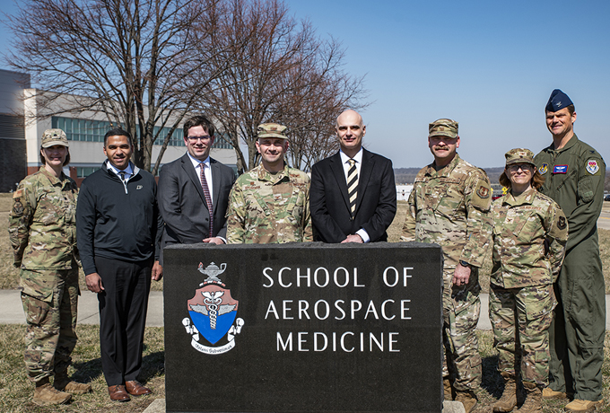 leaders from USAFSAM and Purdue posing around a USAFSAM outdoor sign