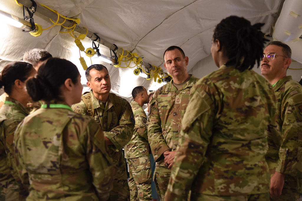 Chief Master Sgt. James Woods, Chief of the Medical Enlisted Force, speaks with Airmen during a site visit showcasing technological capabilities to enhance expeditionary medical care, hosted by the Air Force Medical Command’s A5T, the operational test division under its Capability Development Directorate, at a testing location, Fort Detrick, Maryland, July 24, 2025. (U.S. Air Force photo by Megan Hearst)